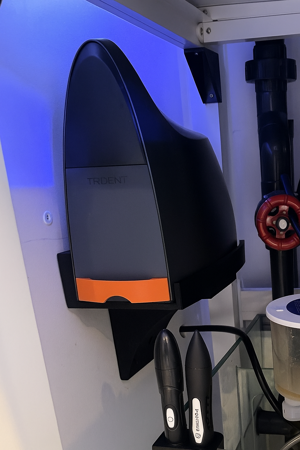 Neptune Trident water analyzer mounted on a black wall bracket, ideal for organized aquarium setups